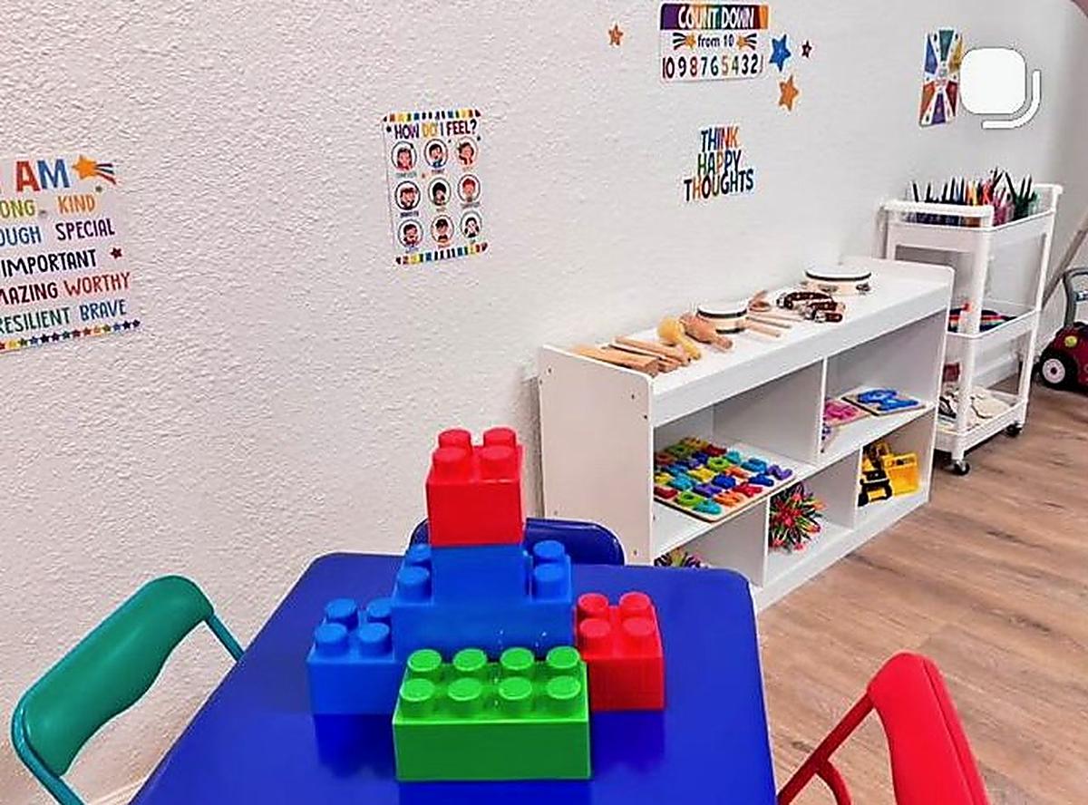 The ECU toddler room with a building table and instrument shelf